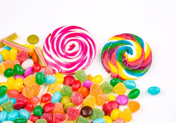 Colorful lollipops and different colored round candy. Top view. Colorful lollipops and different colored round candy. Top view.