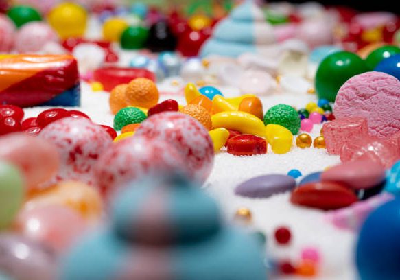 istockphoto-1323715953-612x612 Candy in variety of colour, shape, size and flavours mixed on the table with real white sugar. Shallow depth of field. Sweet stock of snack, chocolates, caramels, candy. Macro.